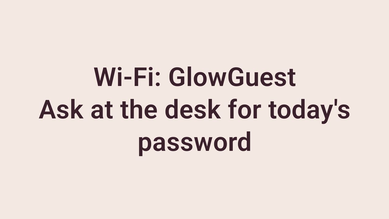 Salon TV slide with the guest Wi-Fi name and a note to ask at the desk for the password.
