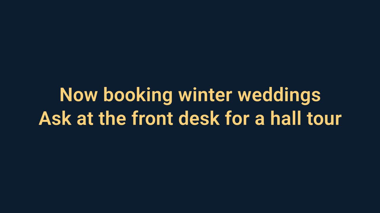 A TV notice: Now booking winter weddings. Ask at the front desk for a hall tour.
