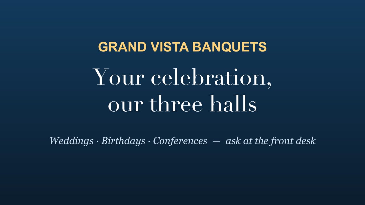 A lobby TV showing the venue's own promo: Grand Vista Banquets, your celebration, our three halls.